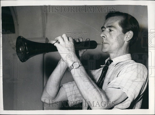 1955, The Chelsea Autumn antiques Fair Mr.I.Mackay tries a shawm - Historic Images
