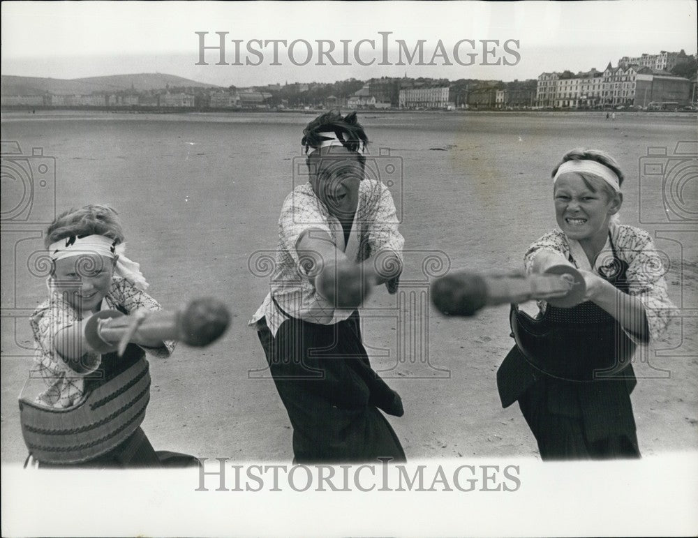 Press Photo  Members of the Maddame family practising kendo on the beach - Historic Images