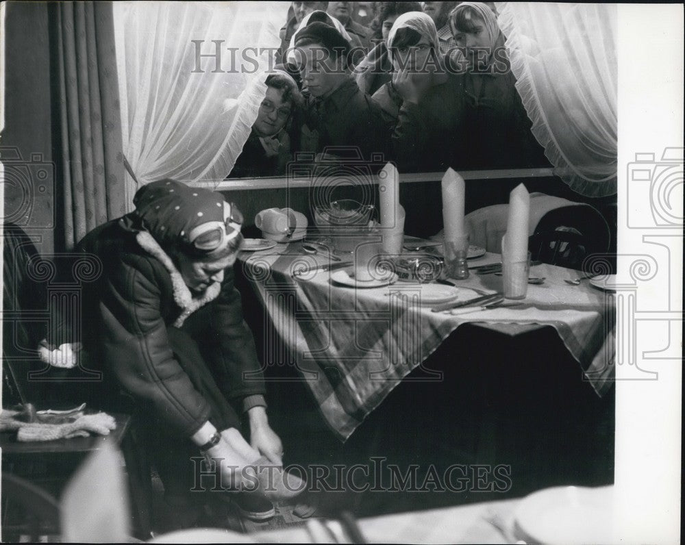 1960 Barbara Moore changes her socks as she takes a rest - Historic Images