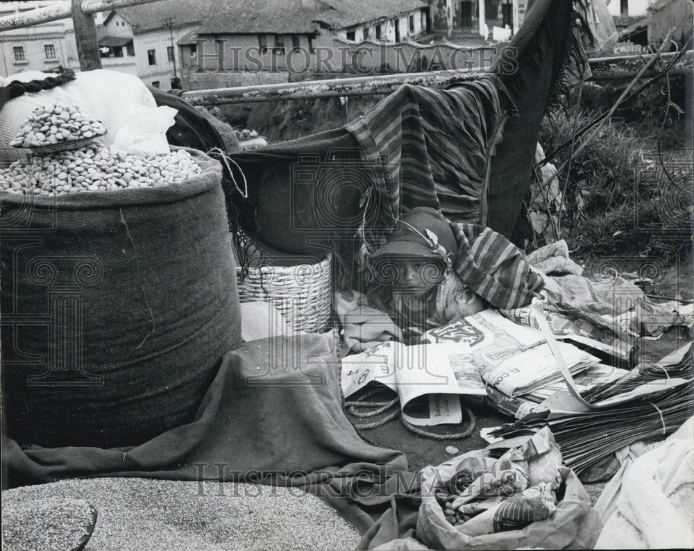 Press Photo tot of a vendor amid the goods at a fair - Historic Images