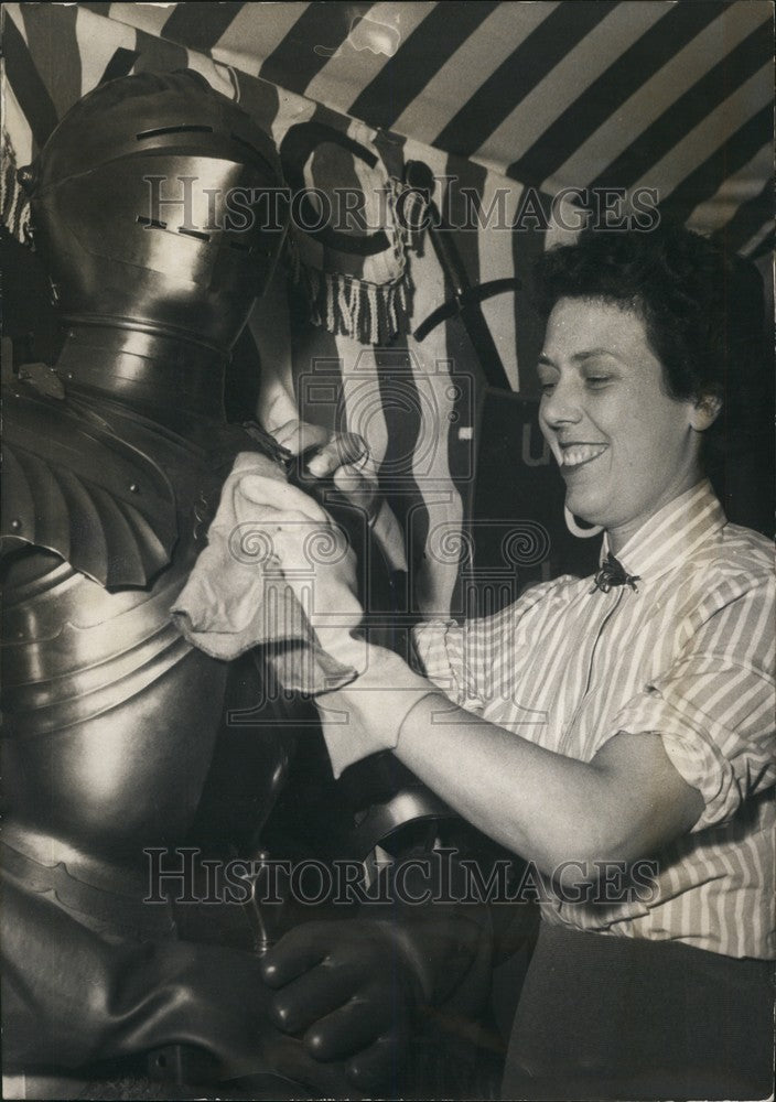 1955 Woman Using Rubber Gloves While Cleaning Knight's Armor - Historic Images