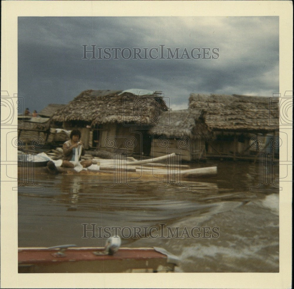 Press Photo Nature Huts & Woman Washing Clothes in Amazon River Peru - Historic Images