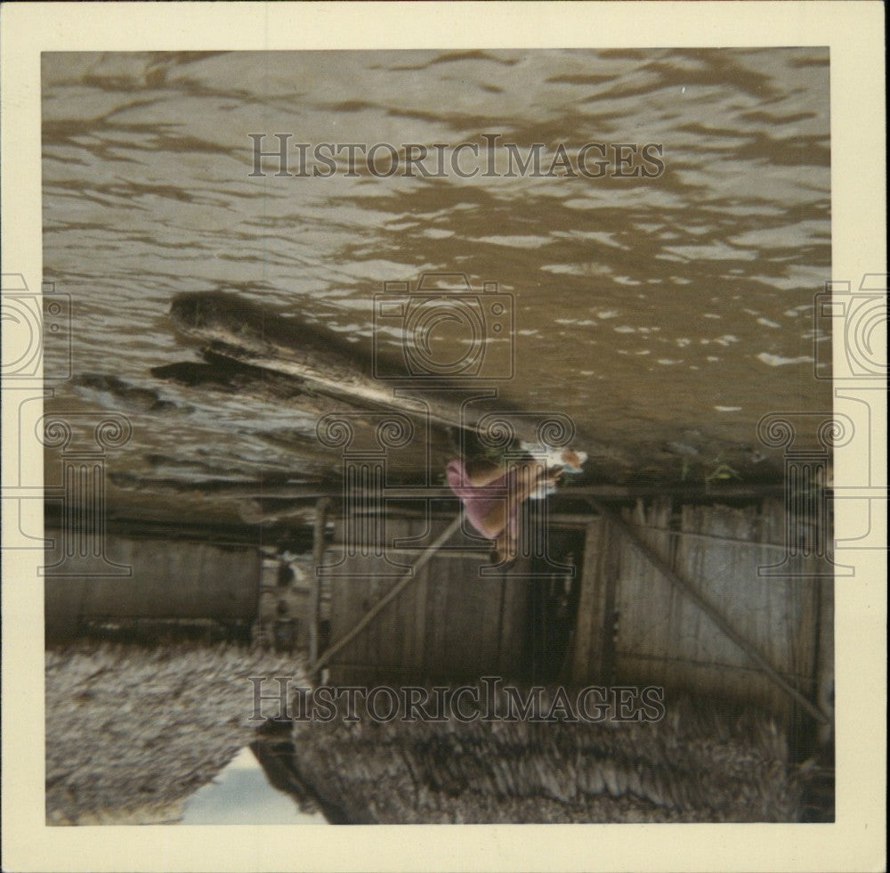 Press Photo woman doing laundry on the Amazon River, Iquitos, Peru - KSB69017 - Historic Images