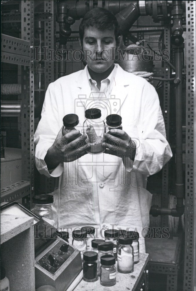 Press Photo Scientist Holding Glass Bottles - KSB72429-Historic Images