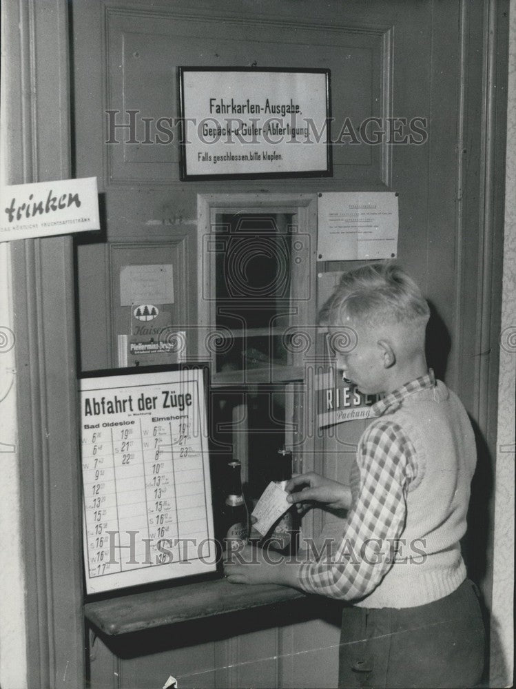 1956 Press Photo Young boy orders ticket and beer at counter in Blumendorf. - Historic Images