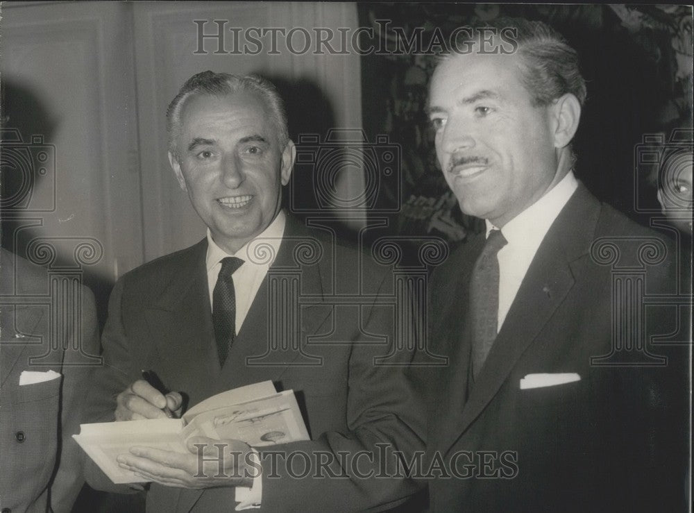 1962 Robert Marchand Autographing his Book for Maurice Herzog - Historic Images