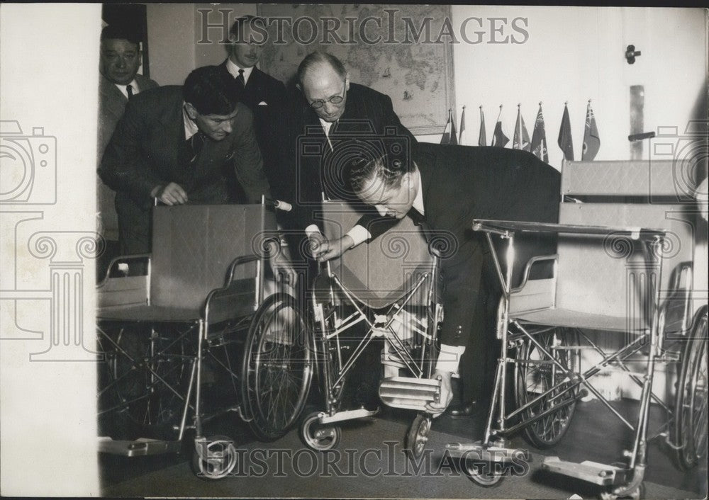 1954 Press Photo Jean Masson, Morel, and Newcomb Examining Wheelchair-Historic Images