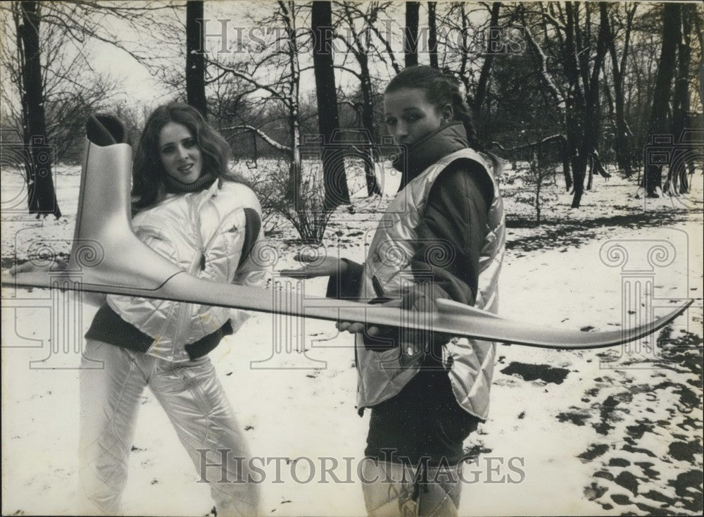 1979 Models Wearing Ski Outfits Present Novelty Ski & Boot in One - Historic Images