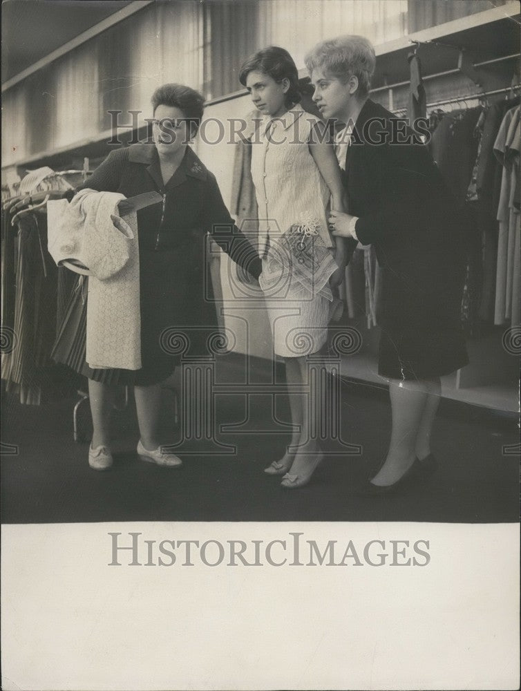1964 Girl Chooses Clothes for "Jugendweihe." East Germany. - Historic Images