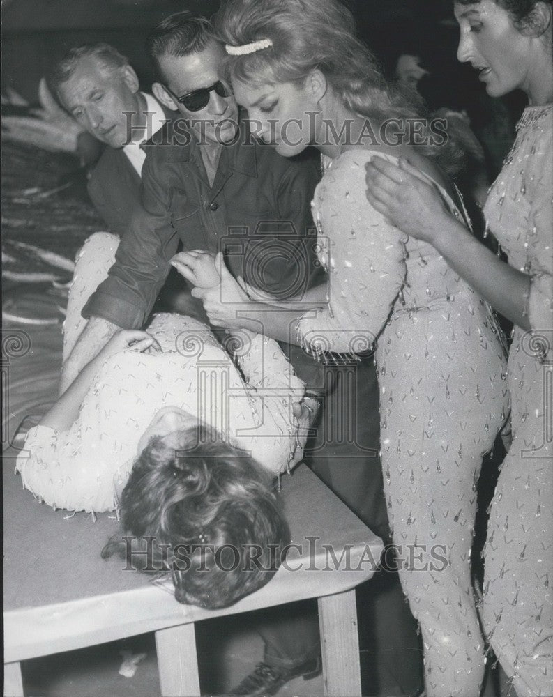 1963 Press Photo Acrobat Laid on Table After Falling From Suspended Ball - Historic Images