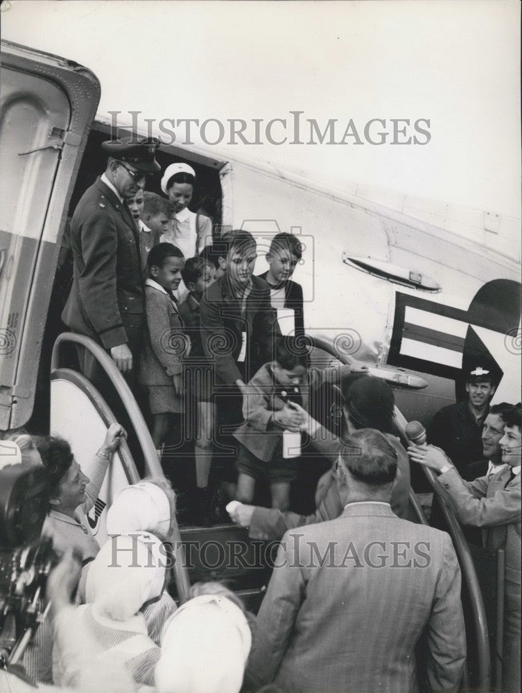 1953 Children on US Airplanes During Air Drops. - Historic Images