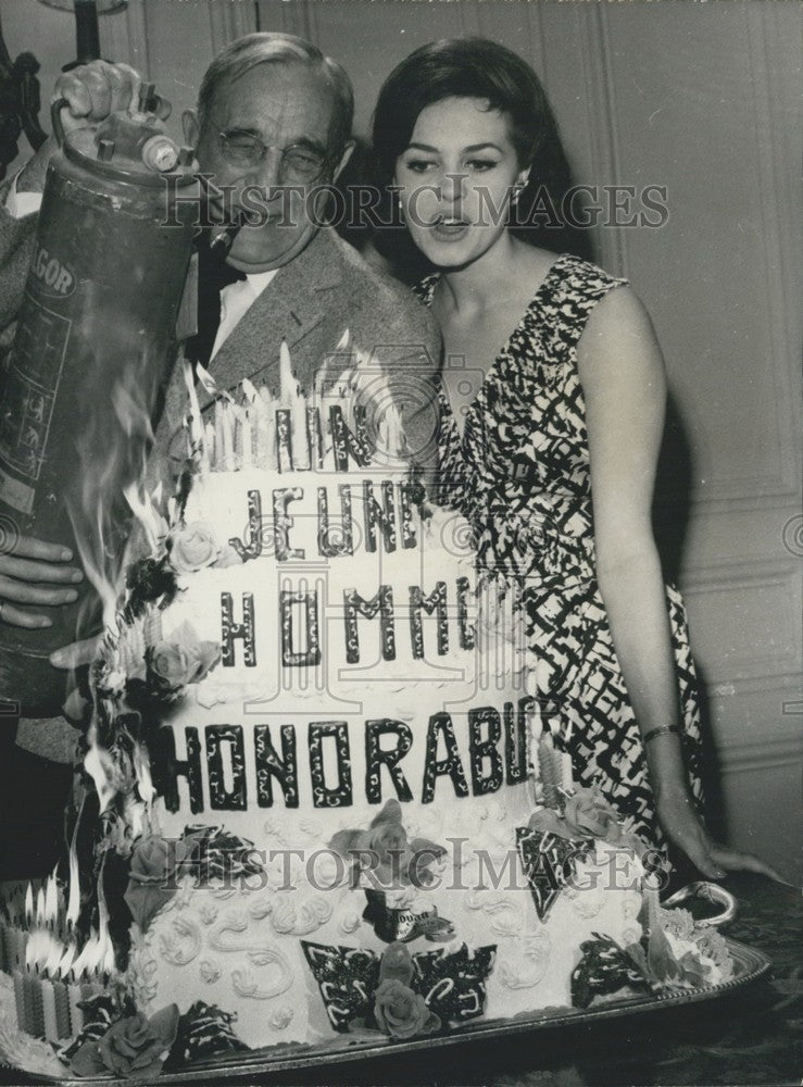 1962 Press Photo Charles Vanel &amp; Michele Mercier Extinguish Burning Cake - Historic Images