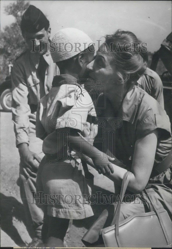 1957 Press Photo Mrs. Salan Kisses Algerian Child-Historic Images