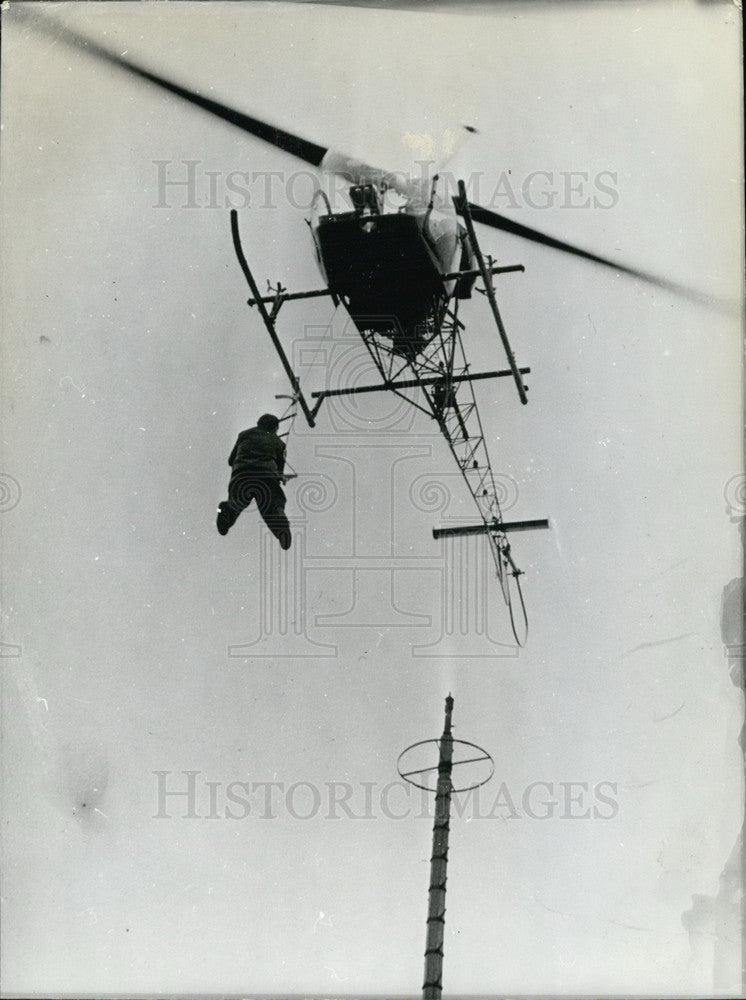 1974, Man under a helicopter - Historic Images