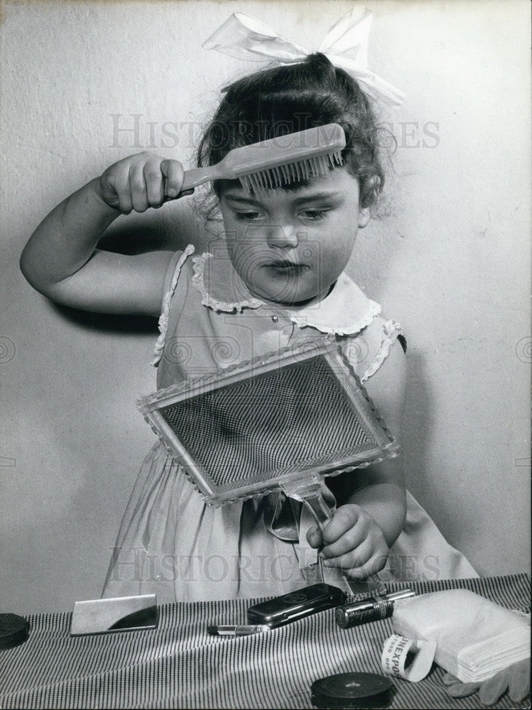 Press Photo Little Girl Brushing Her Hair. - Historic Images