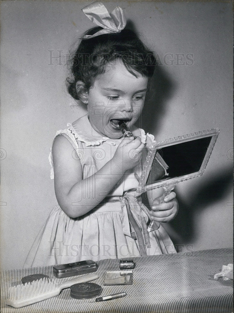Press Photo Little Girl Putting on Cosmetics.-Historic Images