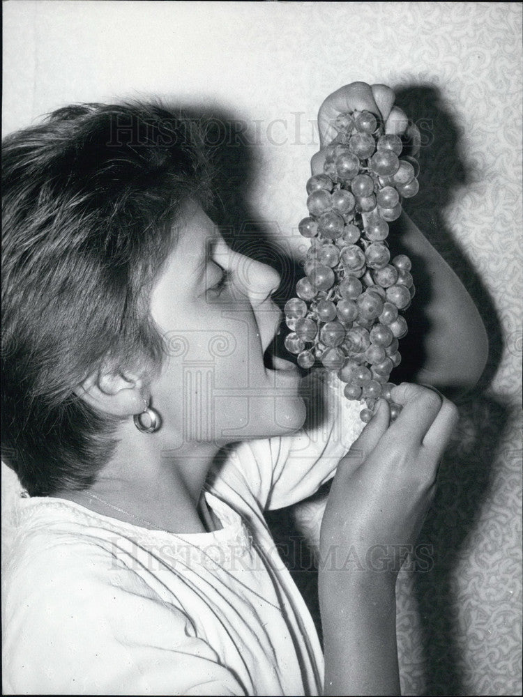 1965 Young Woman Eating Grapes - Historic Images