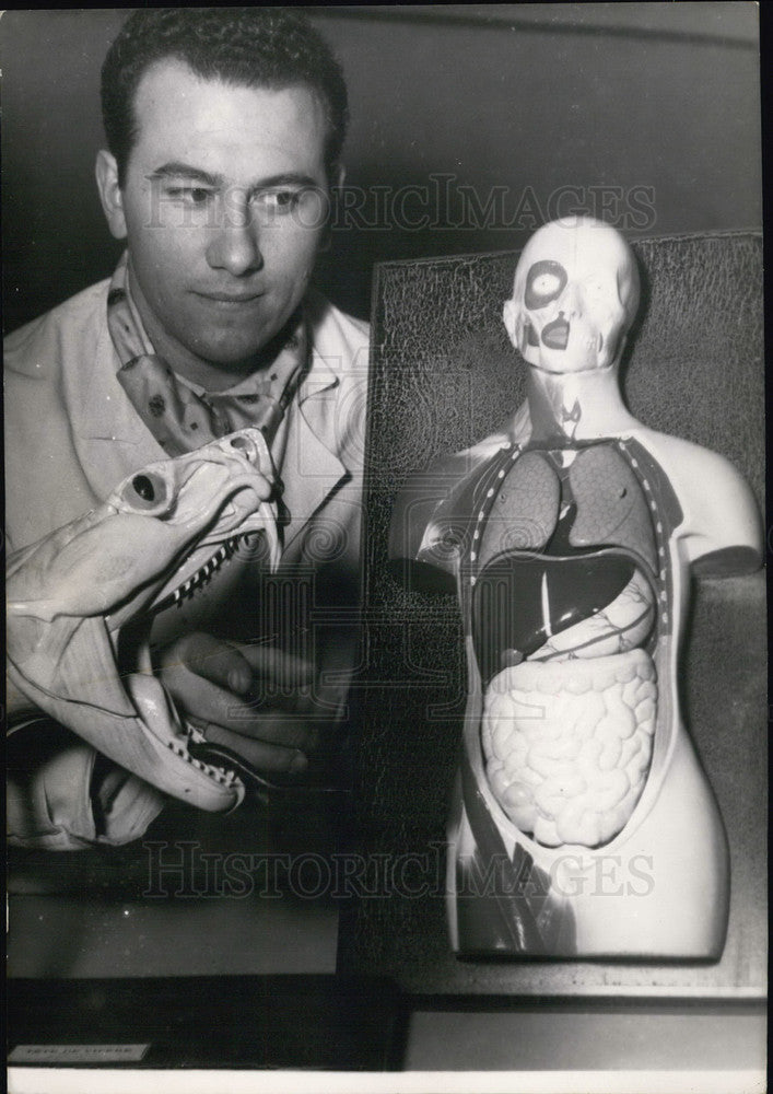 Press Photo Man with Fake Snake Head Model At Paris School Supply Fair - Historic Images