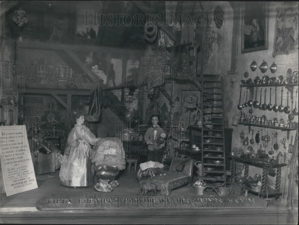 1957, Antique Shop Window Showing a Young Married Couple - Historic Images