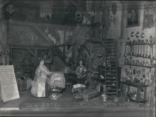 1957, Antique Shop Window Showing a Young Married Couple - Historic Images