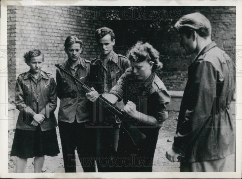 Press Photo East German Girl Loads Gun. - Historic Images