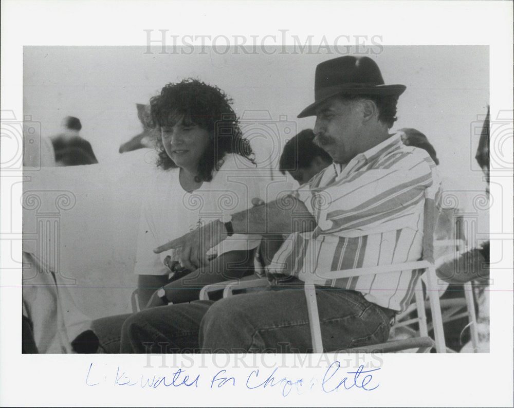 1993 Press Photo lakewater for man and woman chocolate sitting outdoors - Historic Images