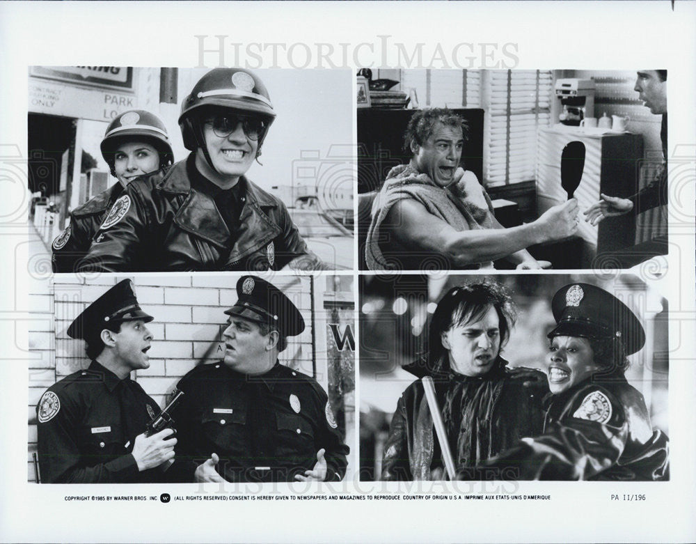 1985 Press Photo movie actors police officers gun helmets mirror - Historic Images