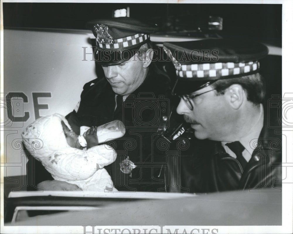 1993  policemen carries an abandon baby - Historic Images