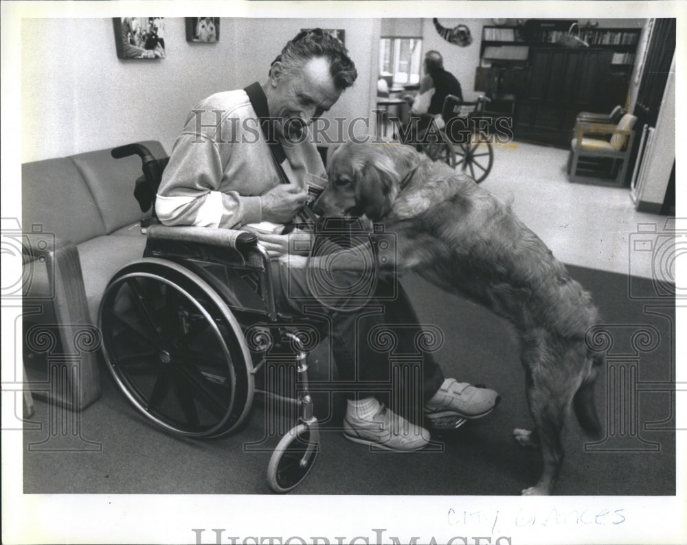 1992 Donald Weld feeds a biscuit to Maggie. - Historic Images