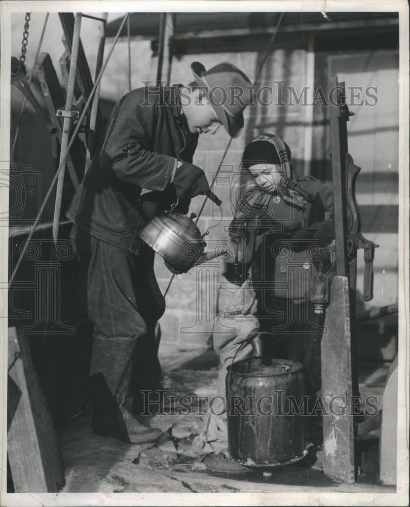 1941 thawing out the pumps down on the farm - Historic Images