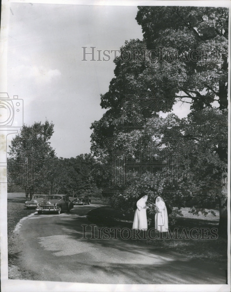 1951 Nuns visit a sugar maple tree. - Historic Images