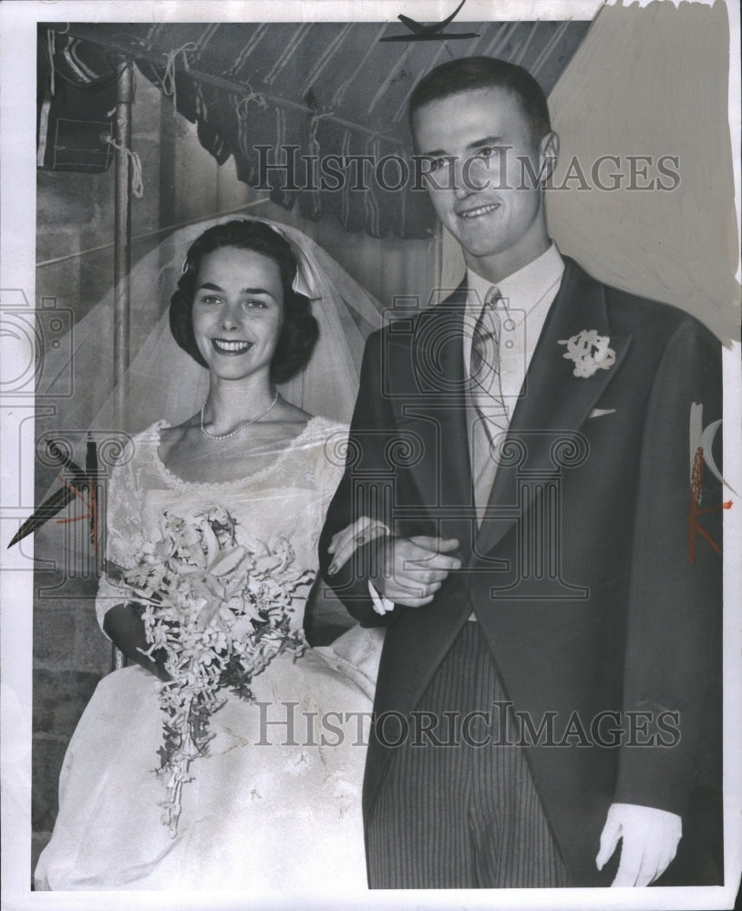 1957 Bride and Groom standing at the alter  - Historic Images