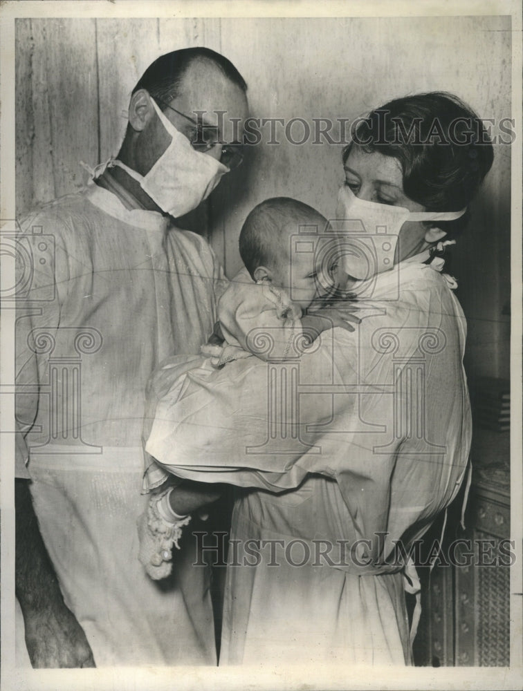 1939 Press Photo Masked Parent Adopt Baby Couple Cradle - RRR67113 - Historic Images
