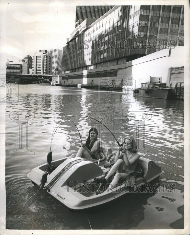 1973 Two bikini clad ladies in a paddle boa - Historic Images