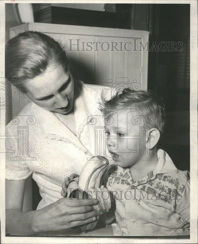 1957 Mother Feeding Child Banana  - Historic Images