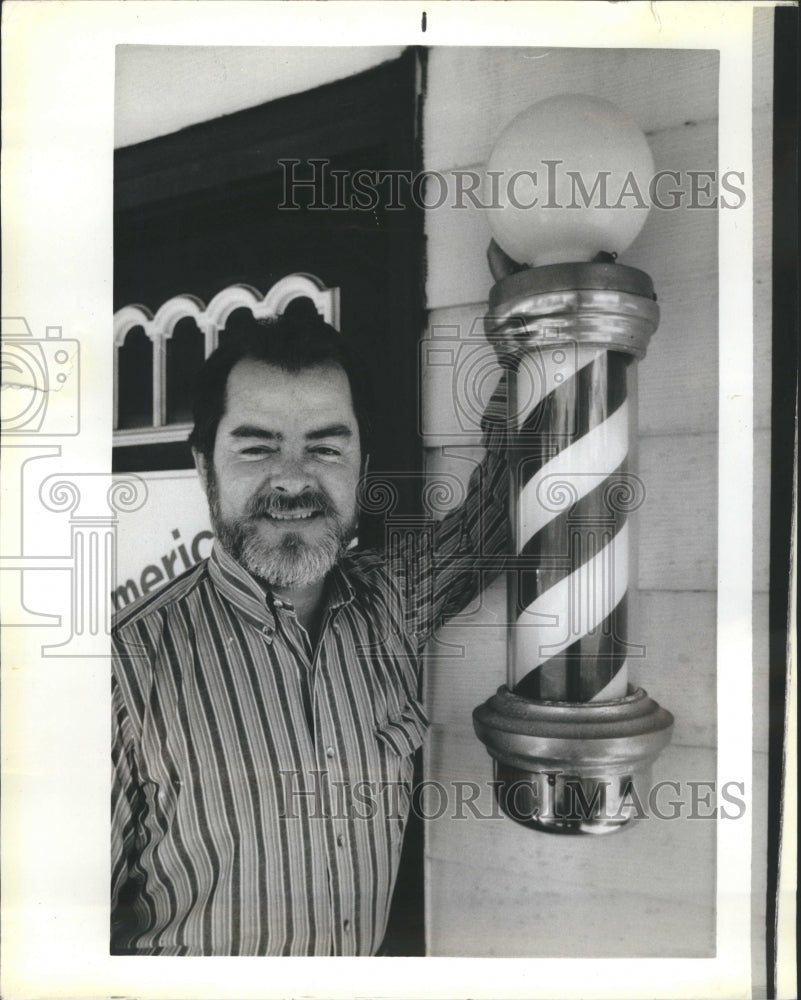 1984 Barber Rodger Pilcher standing in front of his shop - Historic Images