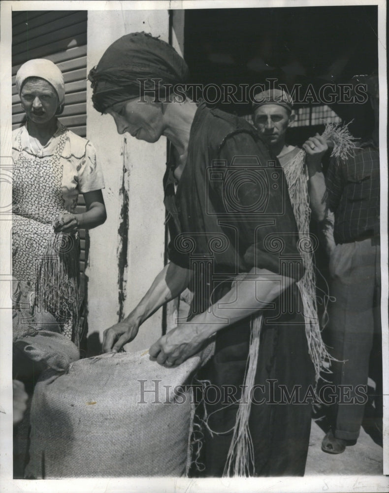 1946 Italian Woman Sews Sack of Wheat - Historic Images