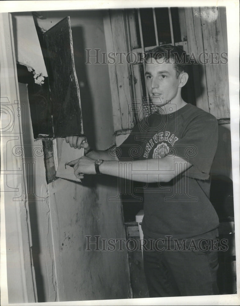 1966 Painter examines torn plasterboard - Historic Images