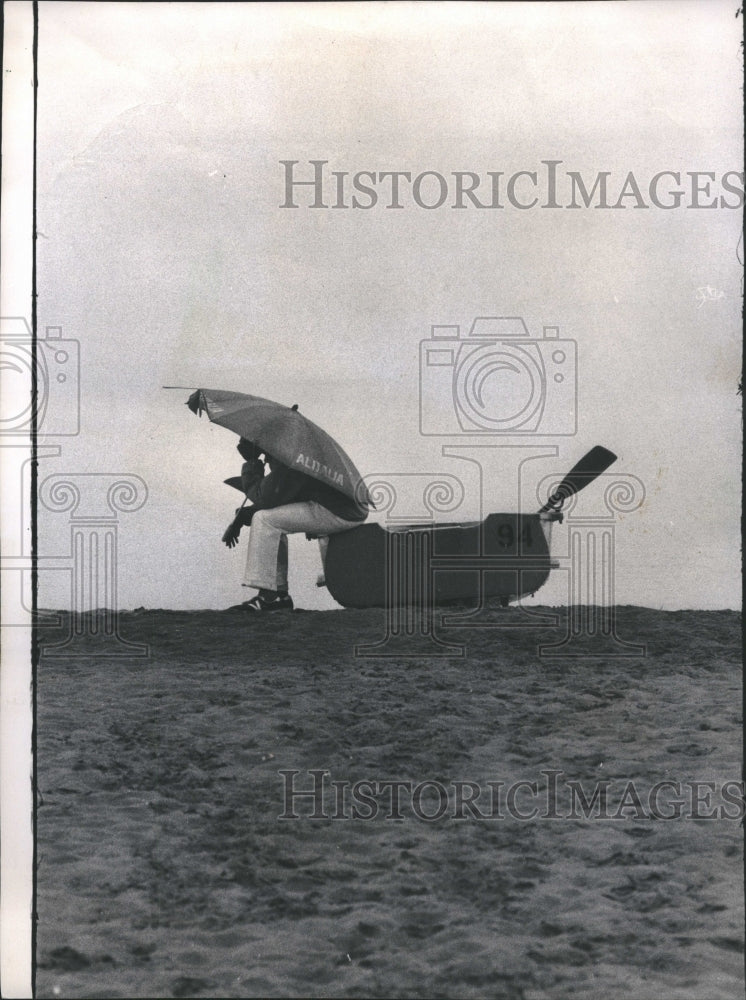 1974 Lifeguard Hides From Rain - Historic Images