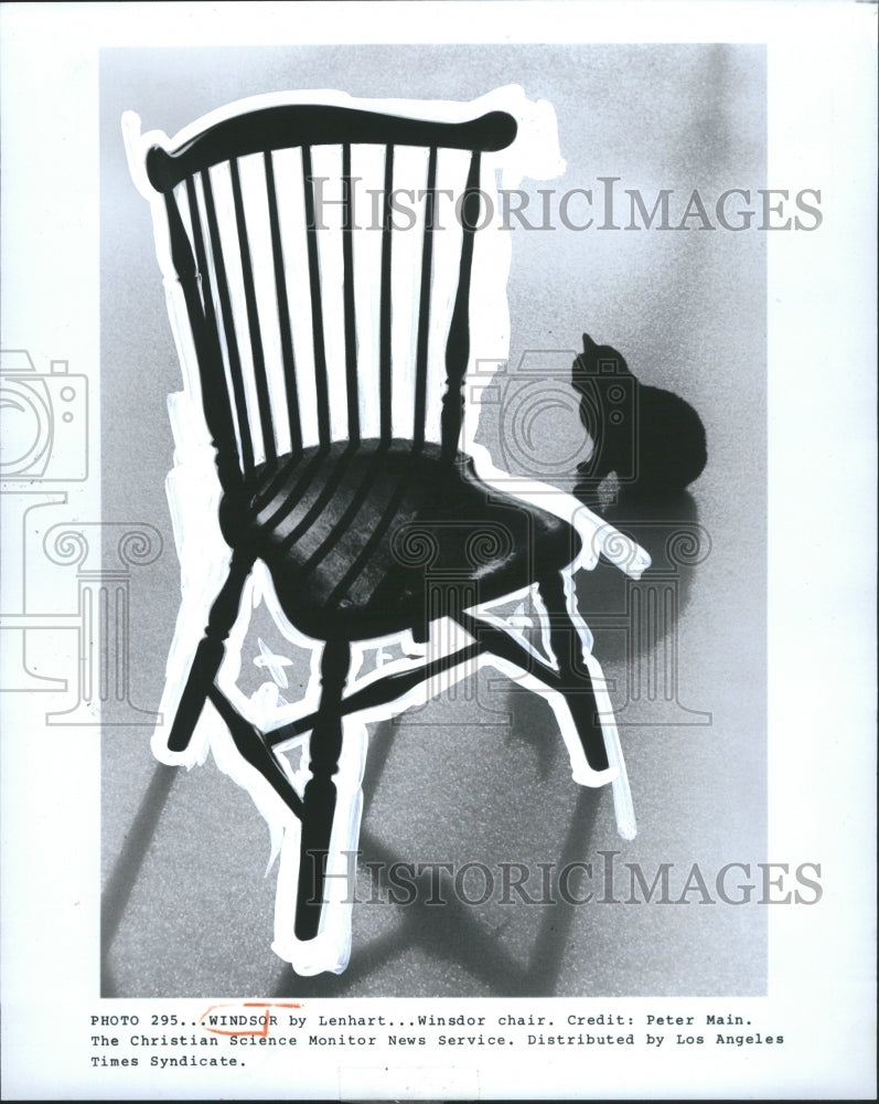 1982 Winsdor Chair and black cat background - Historic Images