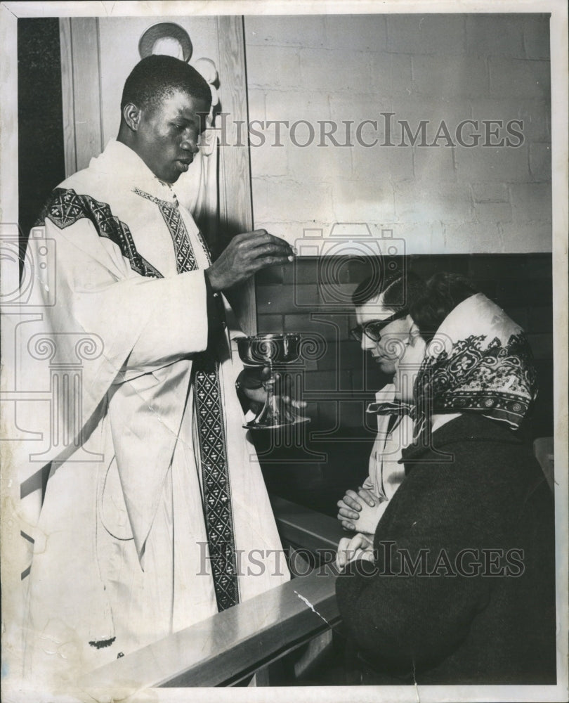 1961 Student Priest giving communion - Historic Images