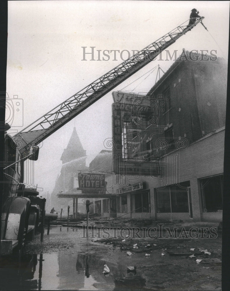 1970 Firemen spray water on Towne hotel - Historic Images