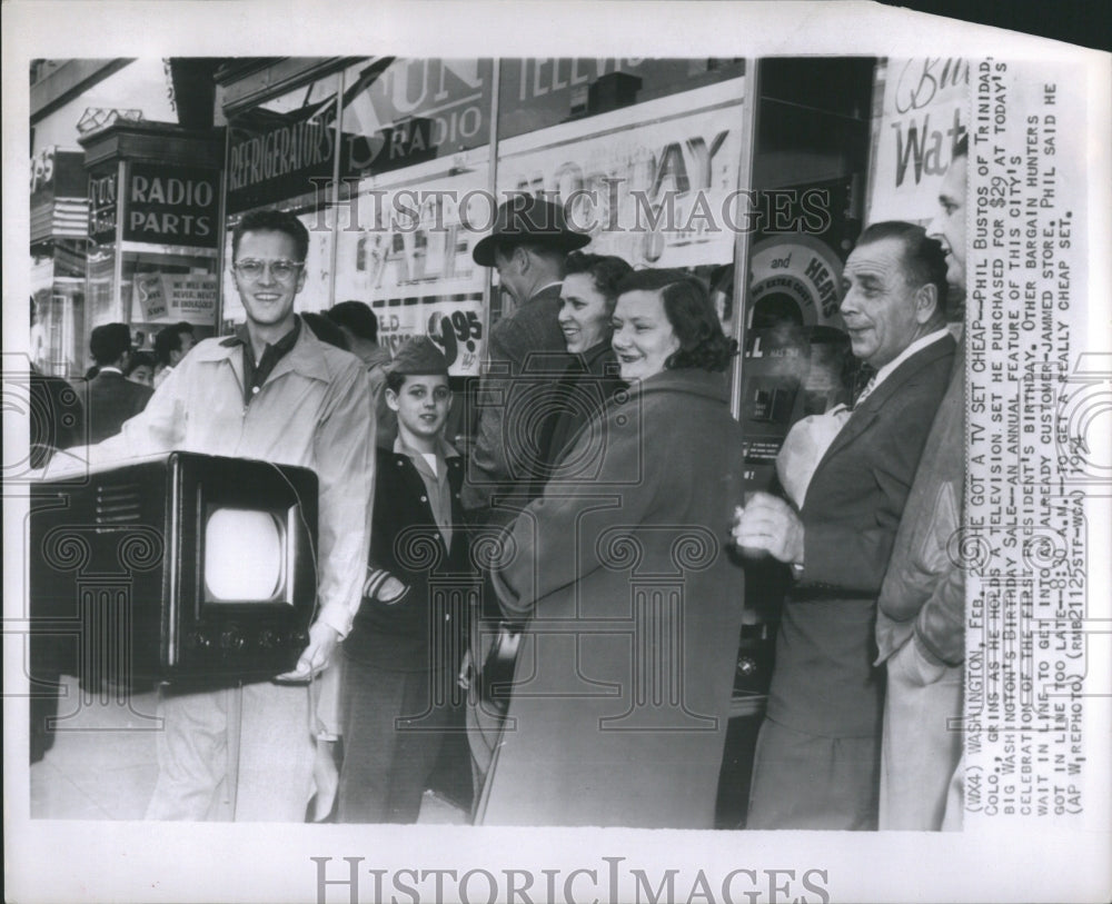 1954 Phils Bustos grins after buying televi - Historic Images