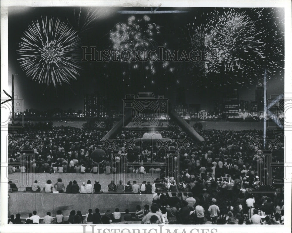 1981 Large crowd watch fireworks in the sky - Historic Images