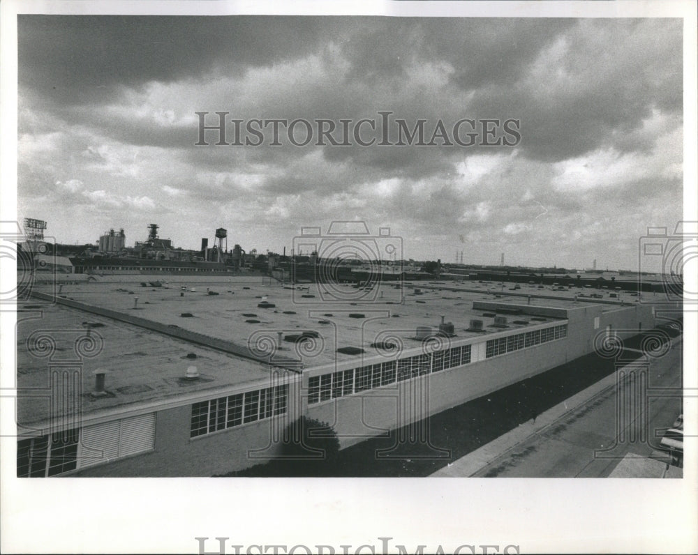 1990 Storm Clouds Loom Over Industrial Park - Historic Images