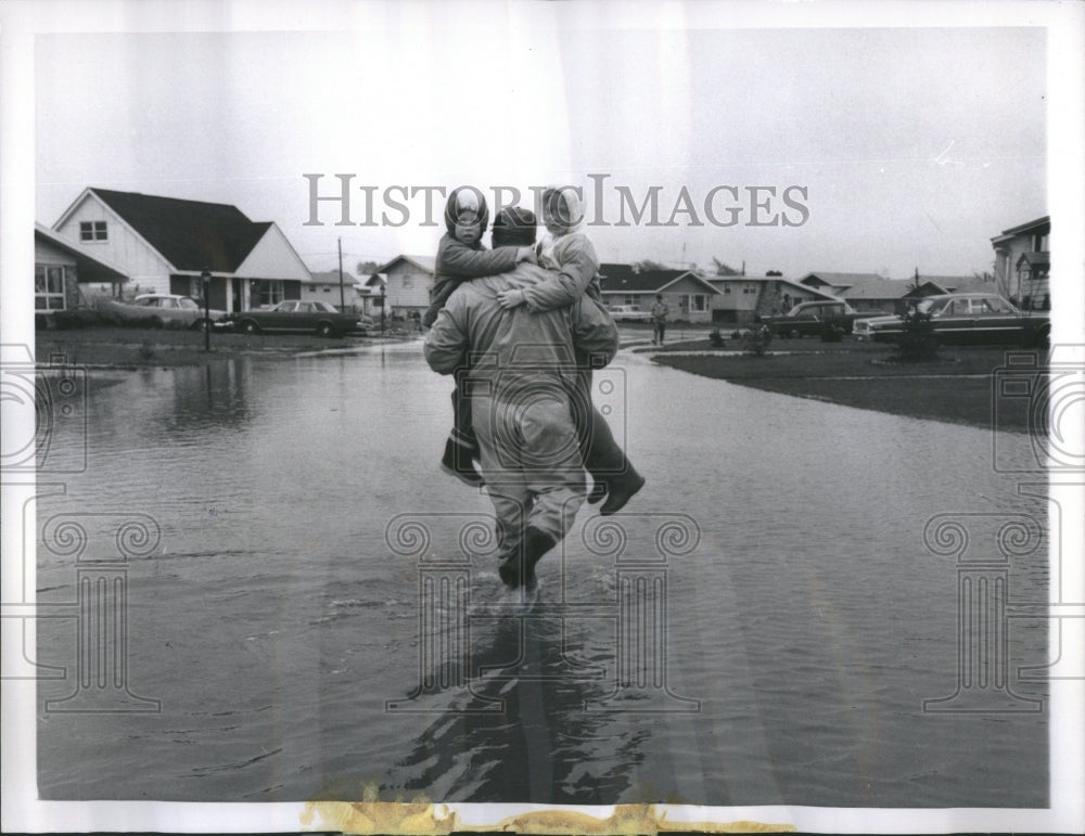 1966 Man Carries His Children Through Flood - Historic Images