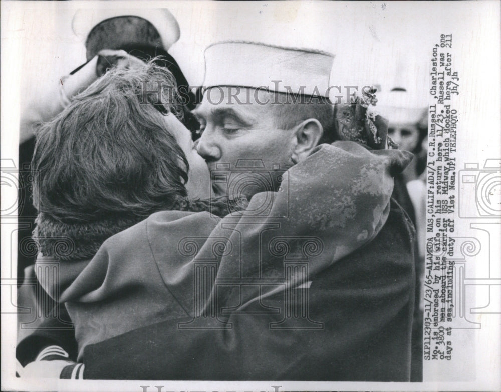 1965 C. R. Russell embraced by wife on his return aboard USS Midway - Historic Images