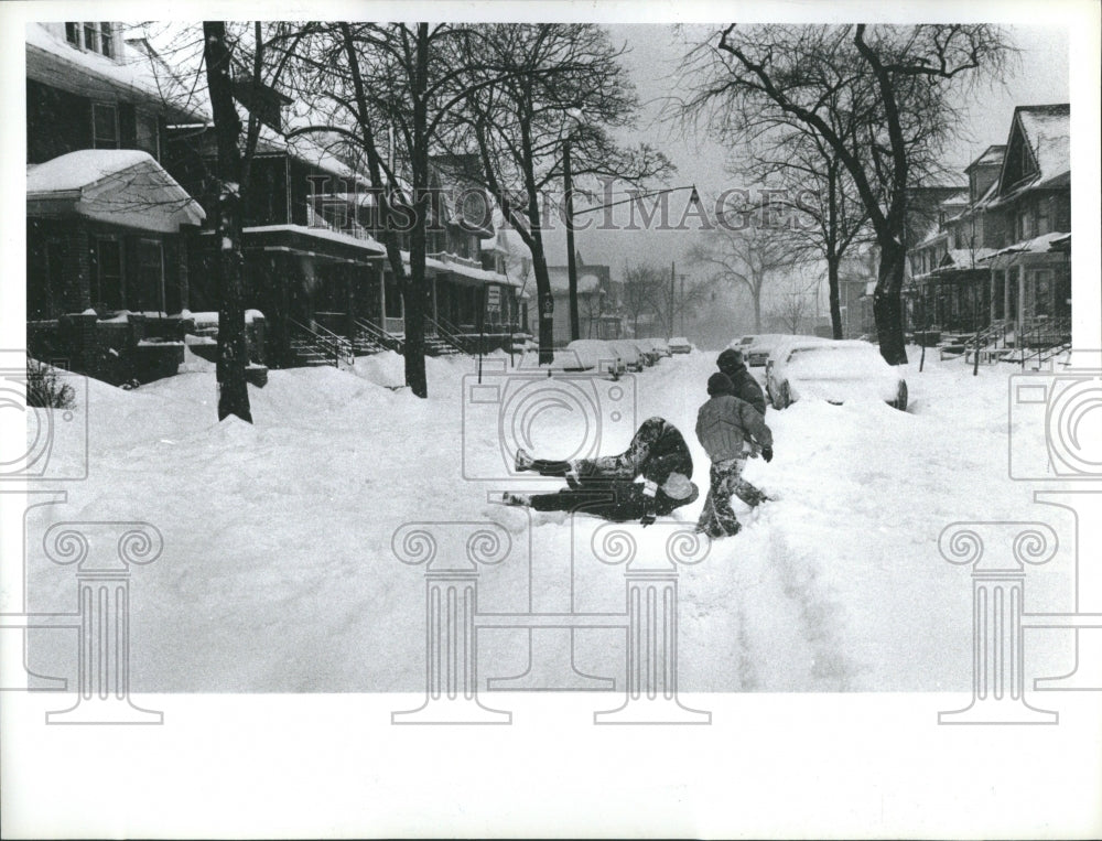 1982 People playing in the snow - Historic Images