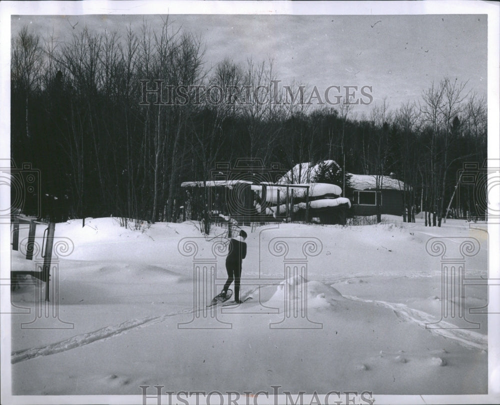 1963 Mrs Bell snowshoesing back to cottage - Historic Images