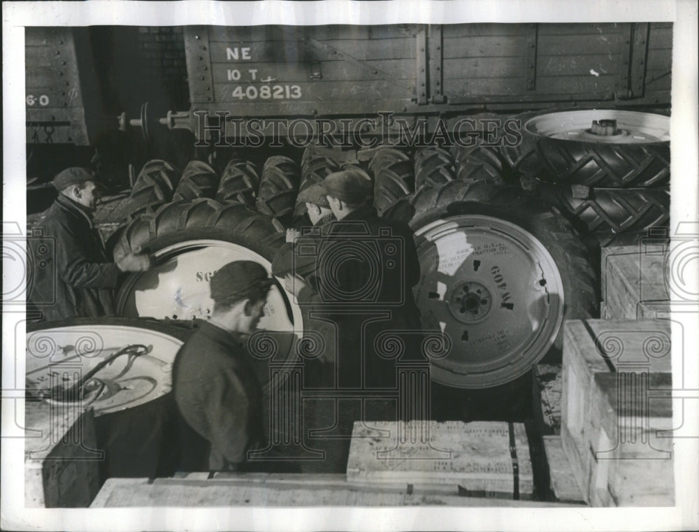 1941 Tractor tires from Ohio being unloaded - Historic Images